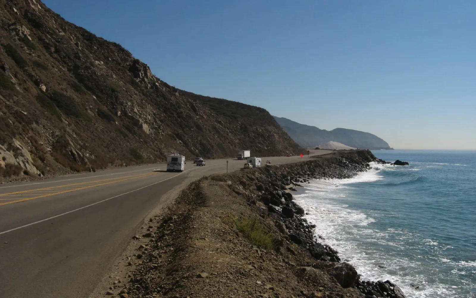 Winding Pacific Coast Highway through the Santa Monica Mountains National Recreation Area, showing the road traversing California's Mediterranean climate landscape